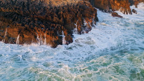 rough marine waves foaming stony shoreline. dramatic wild ocean nature concept