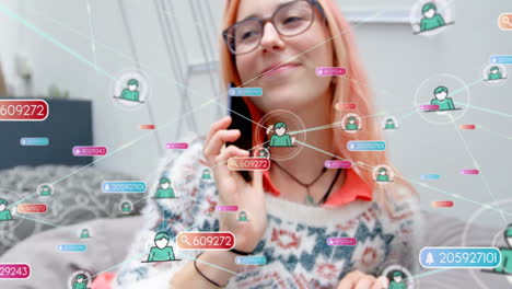 animation of network of connections with people icons over caucasian woman using smartphone