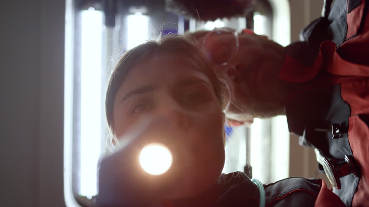 Medical assistants providing checkup of person eyes