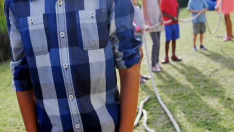 Portrait-of-happy-boy-standing-in-backyard-4k