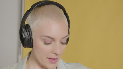 Female model poses with over ear headphones 07