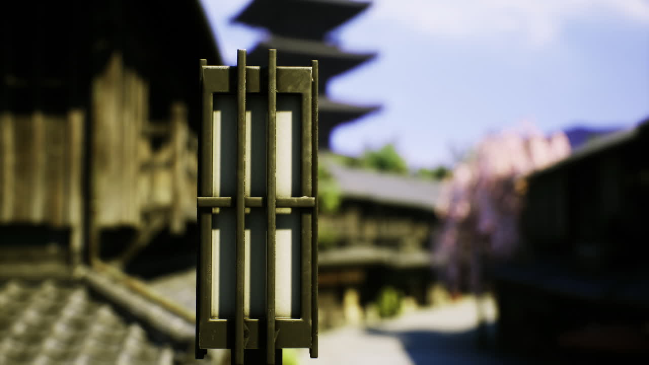 Lantern in traditional village with historic architecture and cherry blossoms