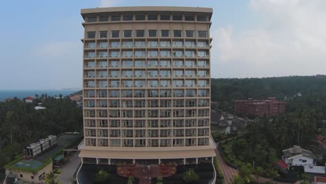 fpv pull back of modern design hotel surrounded by green nature, sri lanka