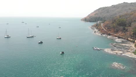 yachts and motorboats at sea on sunny day