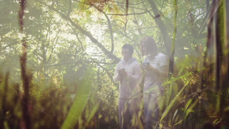 composite of two happy asian women holding tea and walking forest, and moving grass and nature