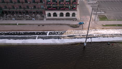 Large-sandbag-barrier-preventing-river-water-from-flooding-nearby-buildings-during-climate-disaster