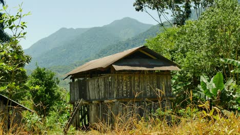 Bolivian-shack-against-distant-green-hills-and-mountains