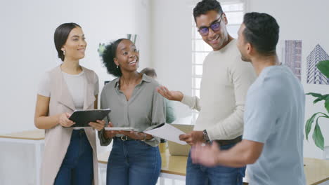 Four-happy-diverse-businesspeople-having-a-meeting