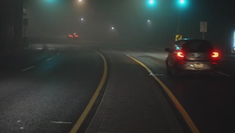 cars on a road on a foggy night - wide, static