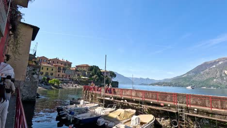 people walking by lake como in varenna