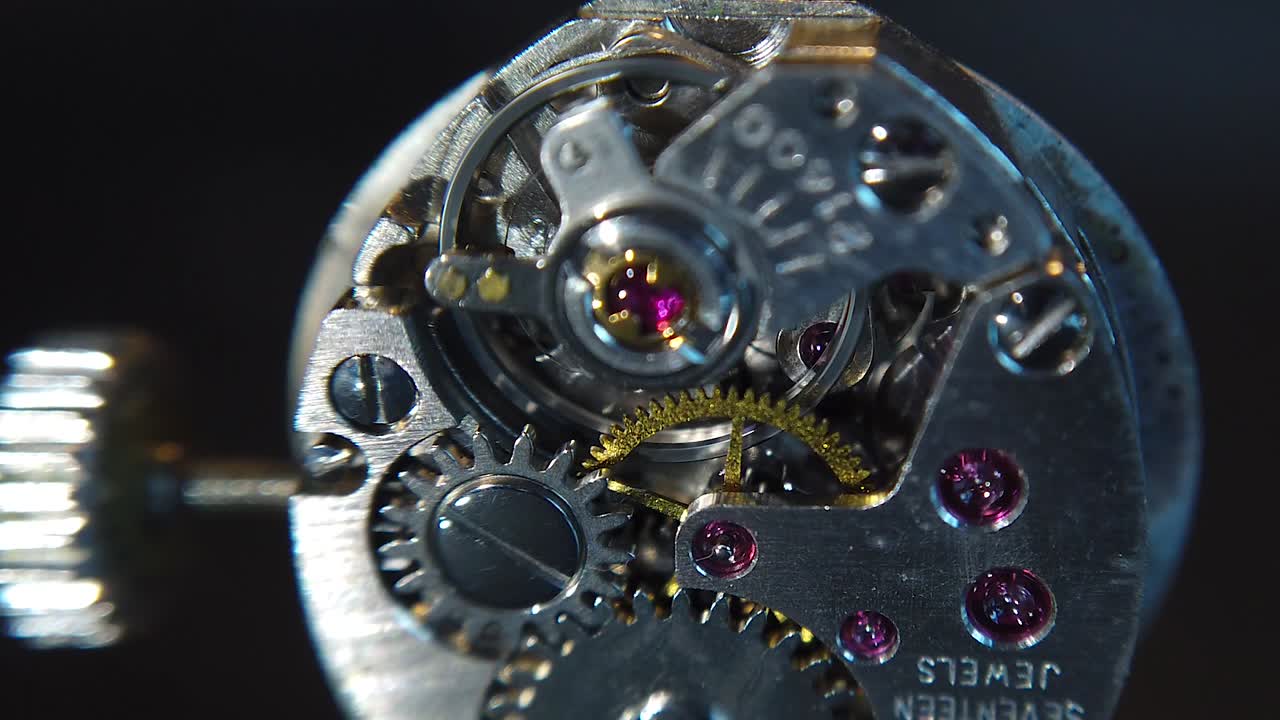A detailed, zoom in shot of the rotating gears inside the wristwatch