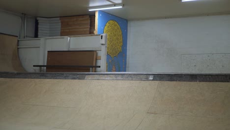 person does a trick on the quarter pipe