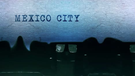 mexico city words typing on a sheet of paper with an old vintage typewriter