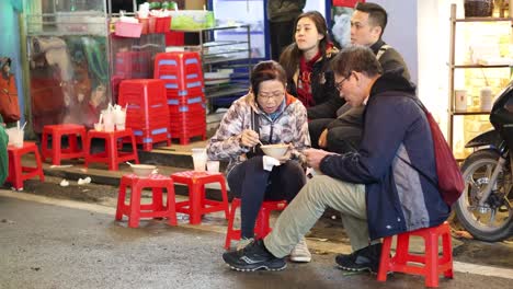 two people sharing food and conversation outdoors