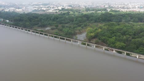 aerial view of a dam and reservoir near a city