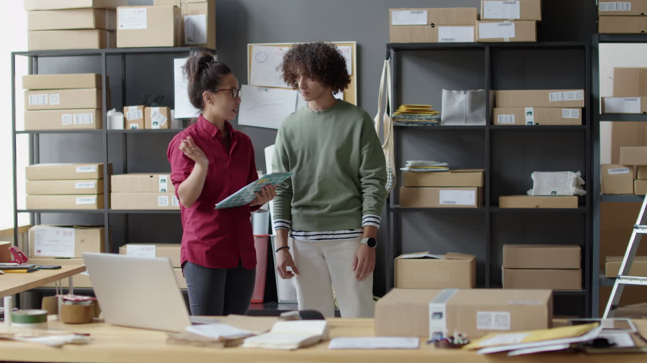 Warehouse workers discussing inventory and deliveries
