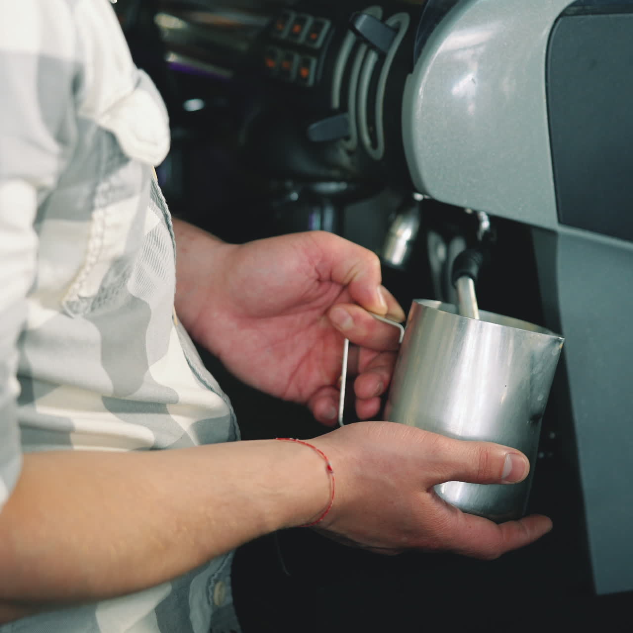 Barista Espresso Preparation. Coffee shop worker steams milk for a hot latte. Latte art coffee Sqare video