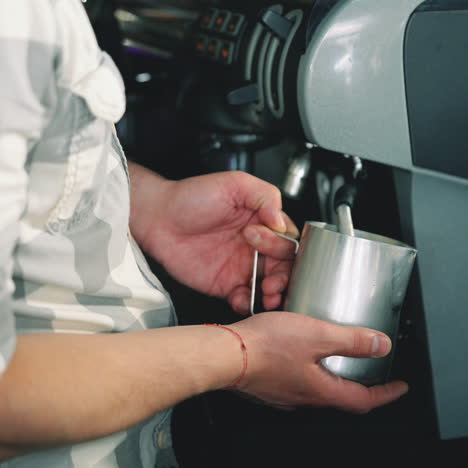 barista espresso preparation. coffee shop worker steams milk for a hot latte. latte art coffee sqare video