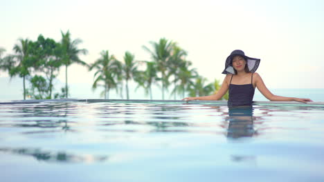 Fit-Asian-woman-standing-in-Swimming-Pool