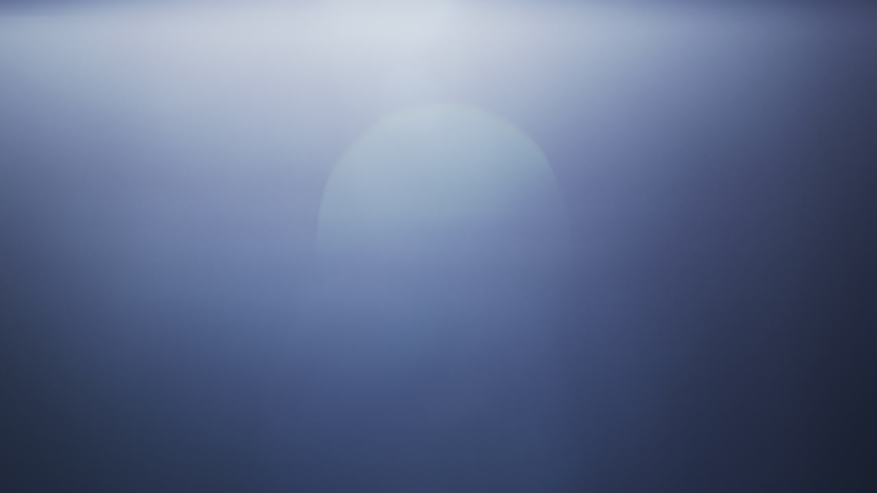 Soft blue lens flare with a gentle light gradient across a clear black background. Ideal for overlays, transitions, visual effects, or adding atmosphere to creative projects