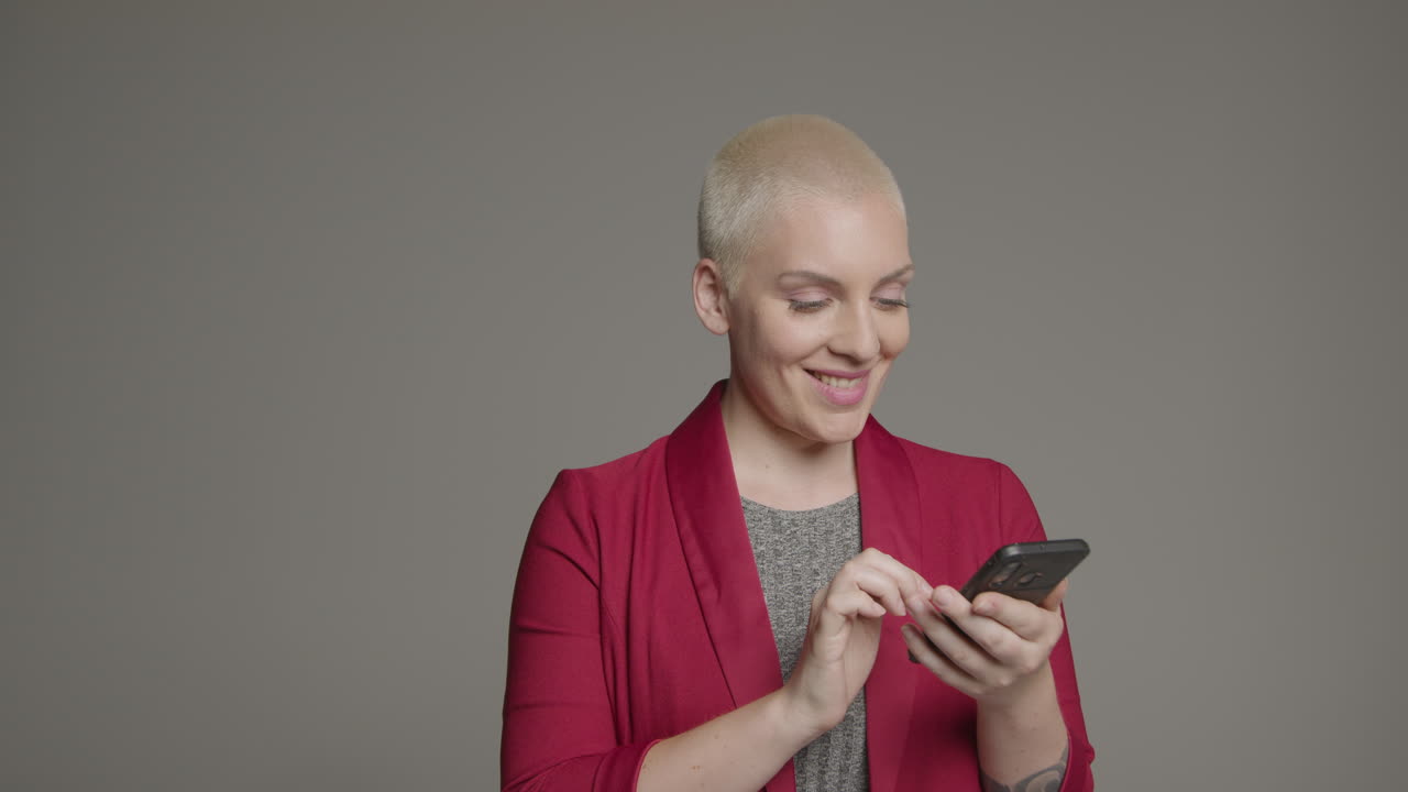 Free stock video - Female model posing with smartphone during studio ...
