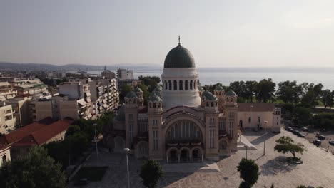 aerial pullback from majestic cathedral of saint andrew in patras coastline, greece