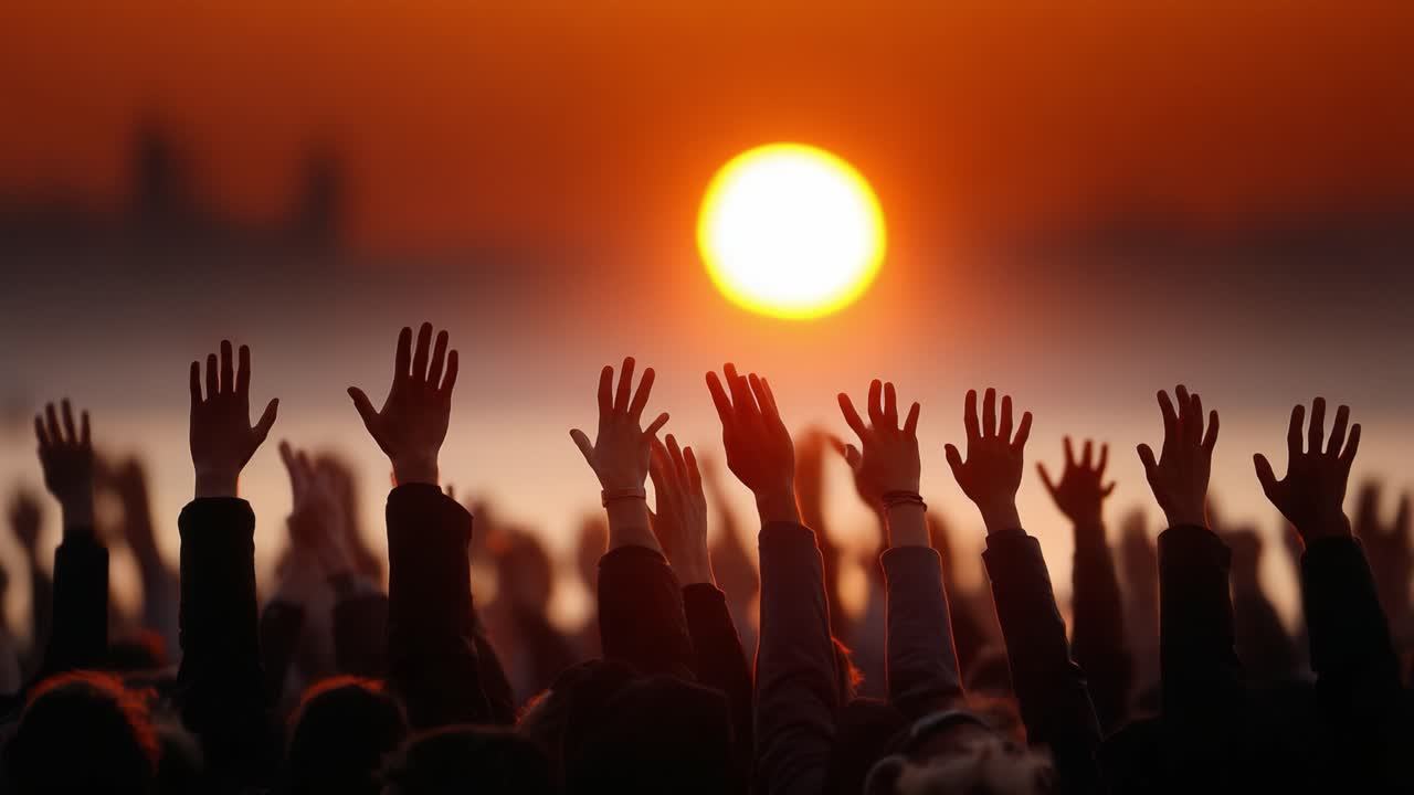 A Spectacular Sunset Illuminates a Sea of Outstretched Hands, Symbolizing Unity and Hope with a Vibrant Sky and Glowing Horizon