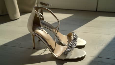 pair of elegant white satin high heels with rhinestones