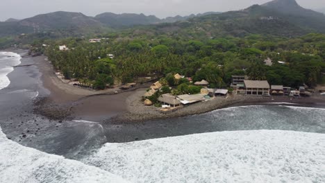 Rotating-beach-aerial-on-tropical-mountain-coastline-of-El-Salvador