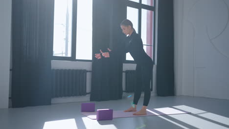 woman practicing yoga in a studio