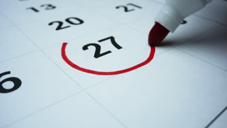 calendario de días laborables. mujer marcando el día en el calendario con un marcador