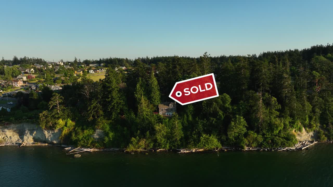 Drone shot approaching a private waterfront cabin with a &amp;quot;SOLD&amp;quot; sign above it