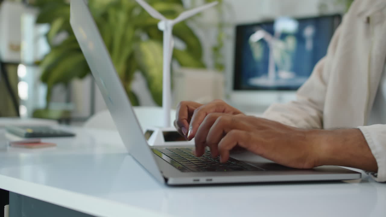 Hands of Man Working on Laptop in Alternative Energy Office