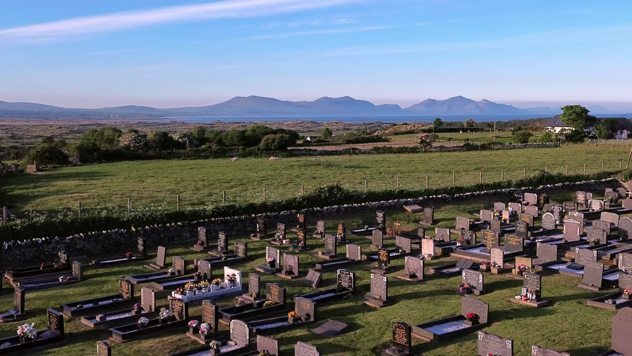 Rural Newborough aerial view across Welsh graveyard in early morning sunrise and idyllic Snowdonia