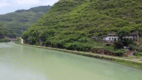 a villager is riding his motorcycle on a beautiful road