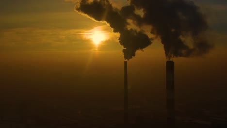 emisiones de la planta de energía vistas sobre la ciudad durante el amanecer