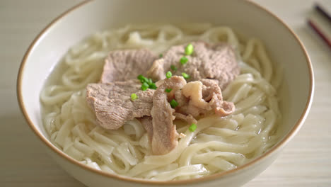 homemade udon ramen noodles with pork in clear soup