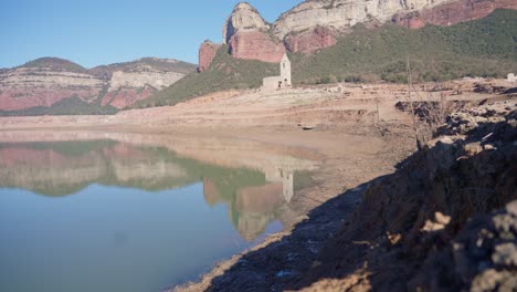 old buildings emerging from empty swamp due to the problems of extreme dryness and lack of rain