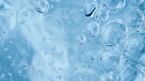 oxygen bubbles in water on a blue abstract background on super slow motion.