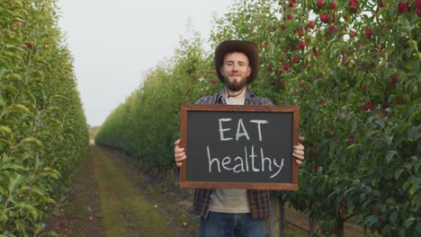 farmer promoting healthy eating in an apple orchard