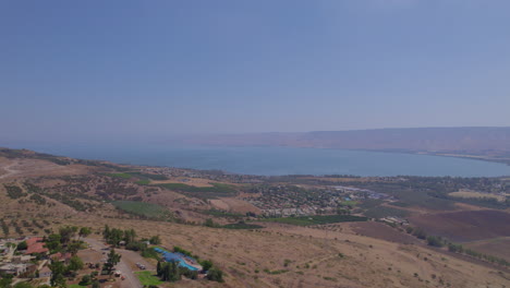 south sea of kinneret above the mountains that surround it - a cloudless summer day - pullback shot