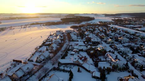 Aerial-Drone-View-Panning-Above-White-Snow-Covered-Rooftops-In-Bright-Winter-Morning-Sun-In-Svitay-City-In-Czech-Republic