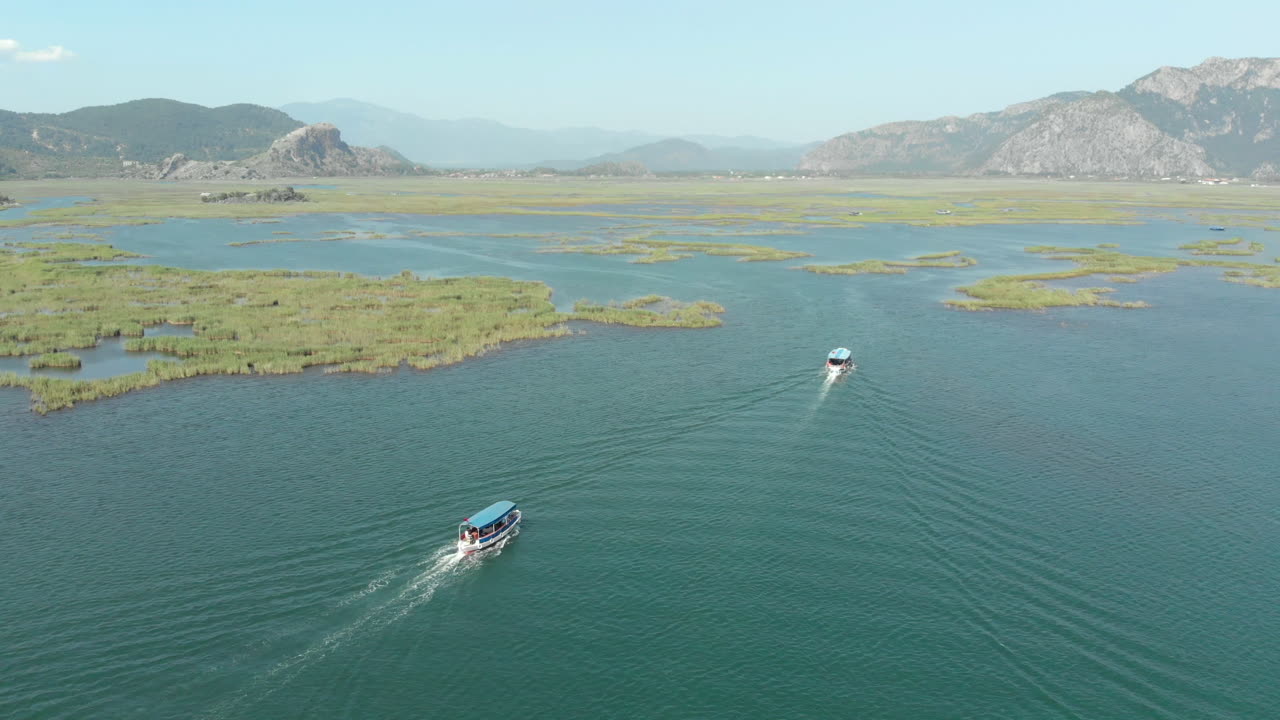 Moving drone shot of River boats in long grass in Turkey