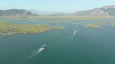moving drone shot of river boats in long grass in turkey