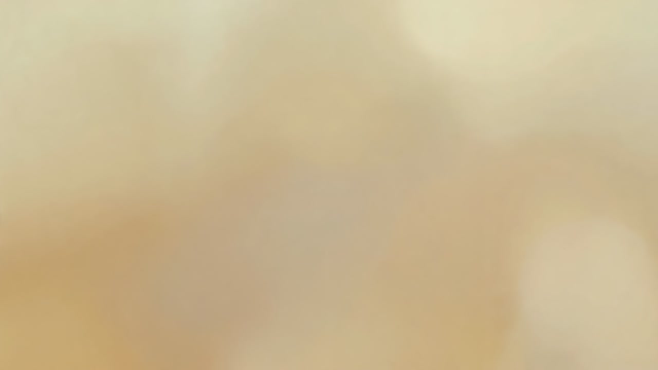 Starting playback abstract footage showing blurry beige-cream gradient on screen, creating mood