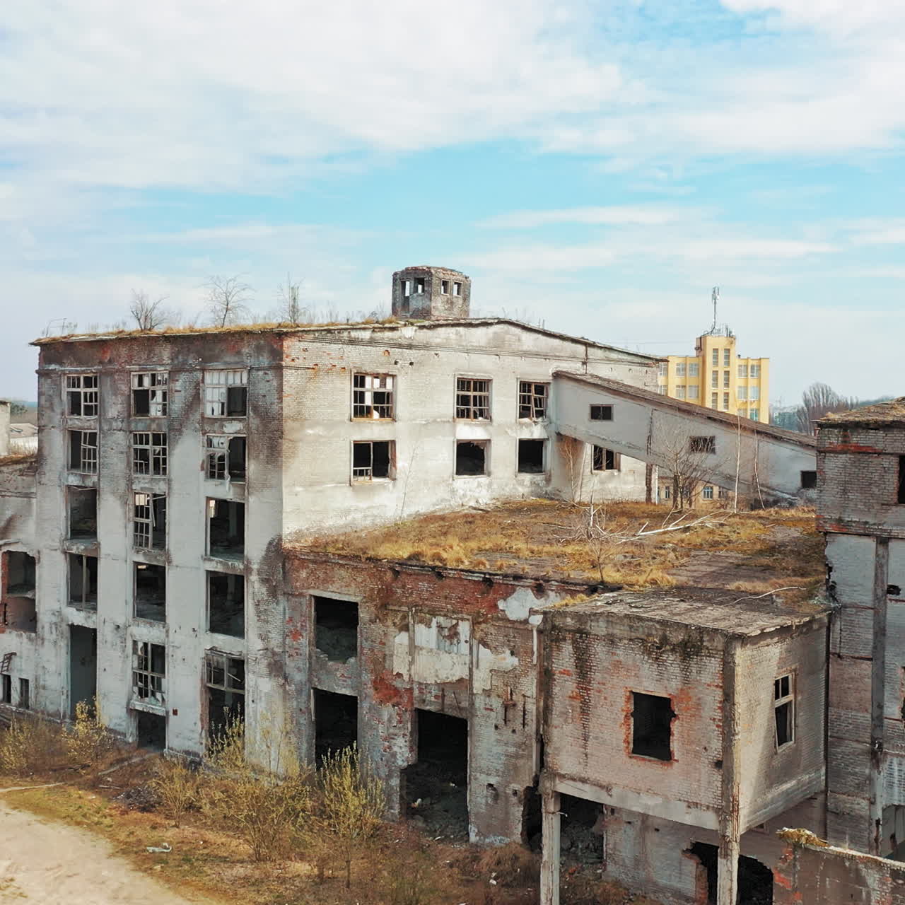 Aerial view of an old factory ruin and broken windows. Old industrial building for demolition.
