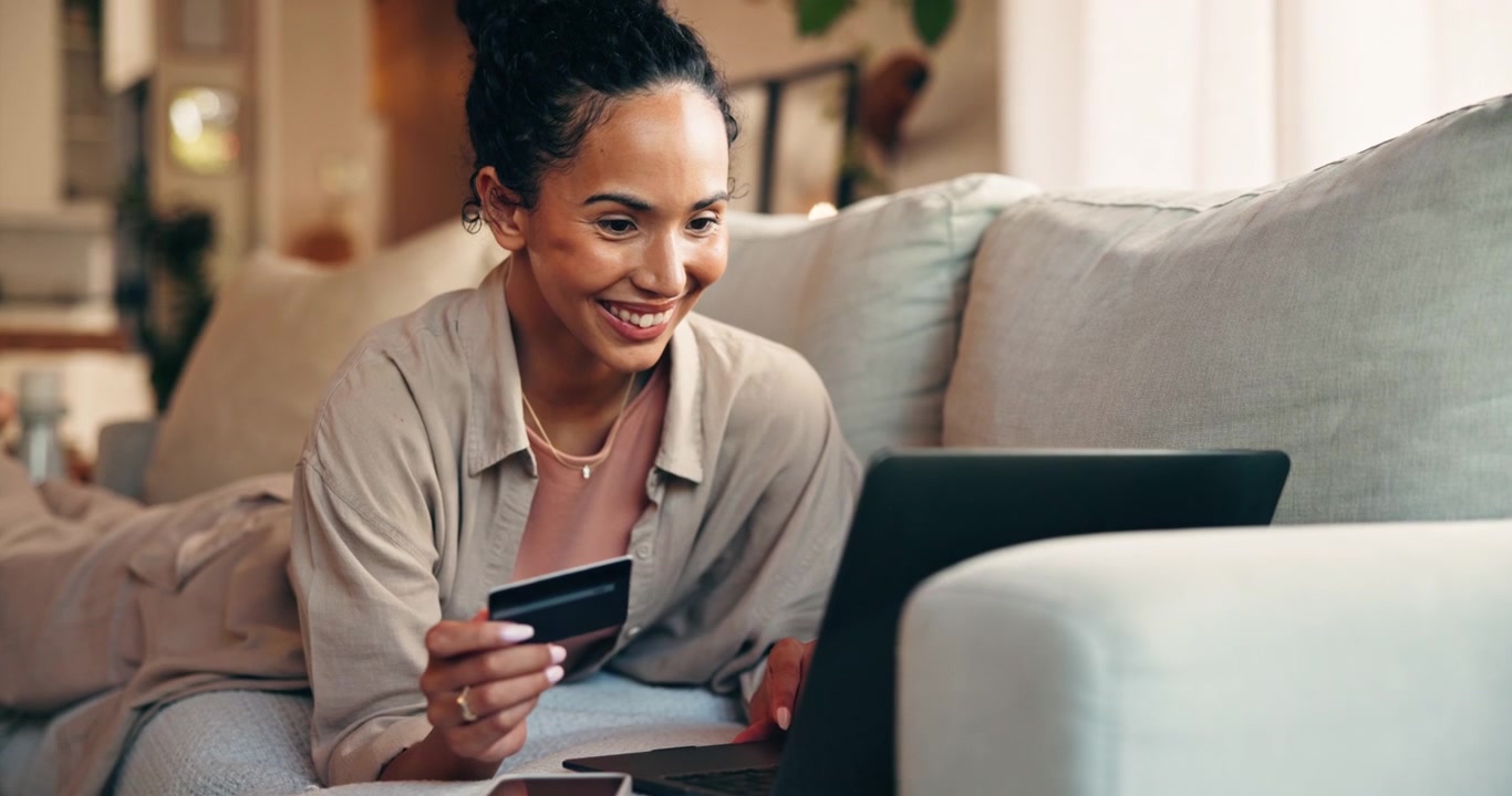 Young Woman Shopping Online with Credit Card on Laptop at Home