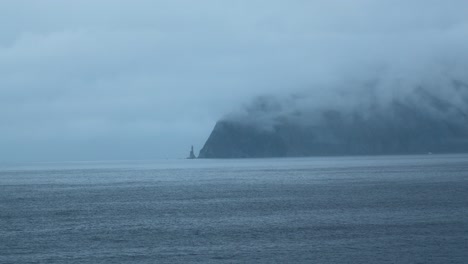 misty coastal landscape with lighthouse