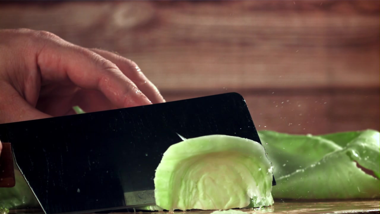 Slow Motion Close-up of Cabbage Being Chopped by a Knife