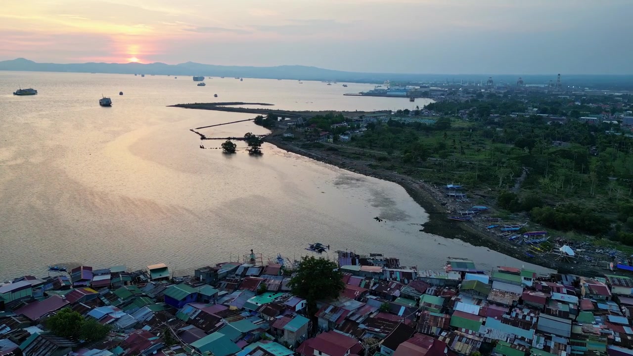 Batangas Körfezi'nde gün batımında, çöplerle kaplı bir sahil şeridinin geriye çekilen drone görüntüsü, çevresel zorlukları ve kıyı bozulmasını gözler önüne seriyor.